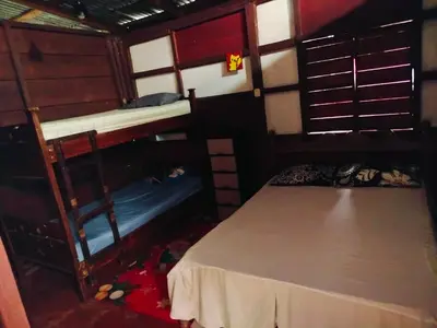 a room with two bunk beds and a bed at Posada Familiar Rìo Celeste in San Rafael