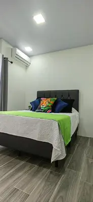 a bedroom with a large bed in a room at APARTAMENTOs HABY 2 in Paquera