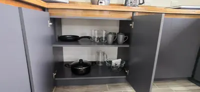 a kitchen with a shelf with utensils on it at APARTAMENTOs HABY 2 in Paquera