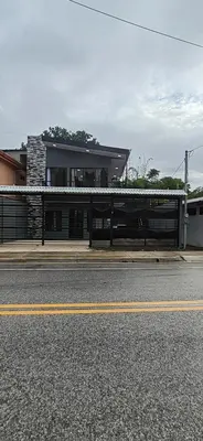 a building on the side of a street with a road at APARTAMENTOs HABY 2 in Paquera