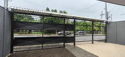 a glass garage door with a car on a road at APARTAMENTOs HABY 2 in Paquera