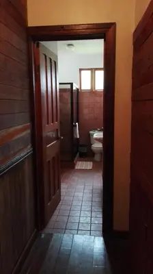 an open door to a bathroom with a toilet at Finca Queveri in Orosí