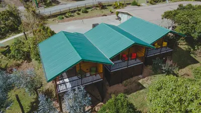 an overhead view of a house with a blue roof at Cabinas El Quetzal in San Gerardo de Dota