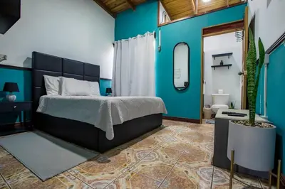 a bedroom with a bed and a blue wall at Casa Chelis in Fortuna