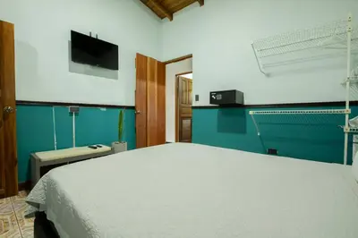 a bedroom with a bed and a flat screen tv at Casa Chelis in Fortuna