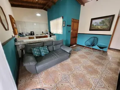 a living room with a couch and a kitchen at Casa Chelis in Fortuna