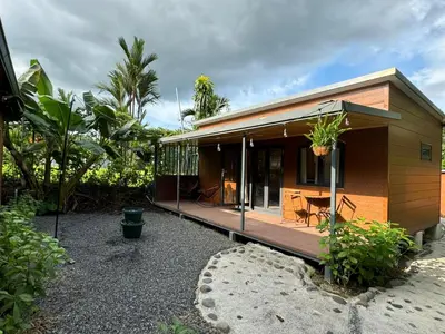 a house with a large deck with a patio at Bungalows at Residencias Arenal in Fortuna