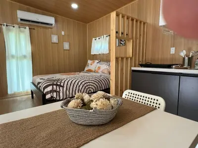 a small room with a bed and a basket of stuffed animals at Bungalows at Residencias Arenal in Fortuna