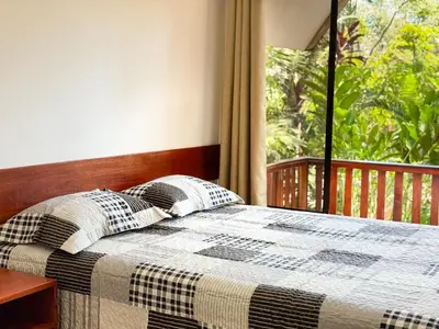 a bedroom with a bed with a view of a porch at Oro Verde Lodge in Fortuna