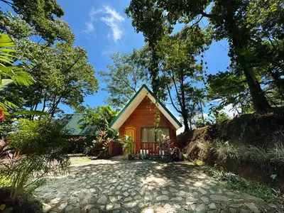 a small cabin in the middle of a garden at Oro Verde Lodge in Fortuna