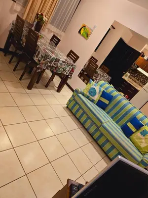 a living room with a couch and a table and chairs at Condominio Coco Marindo #34 in Coco