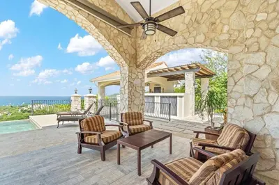 a patio with chairs and a ceiling fan at Luxurious 3 Bedroom Villa in Coco