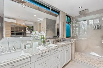 a bathroom with two sinks and a large mirror at Luxury Retreat Oceanview w Fitness Studio in Playa Hermosa