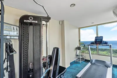 a fitness room with a treadmill and a gym at Luxury Retreat Oceanview w Fitness Studio in Playa Hermosa