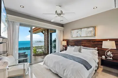 a bedroom with a large bed and a large window at Luxury Retreat Oceanview w Fitness Studio in Playa Hermosa