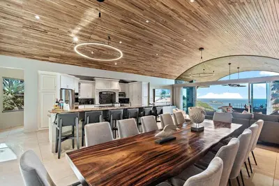 a dining room with a large wooden table and chairs at Luxury Retreat Oceanview w Fitness Studio in Playa Hermosa