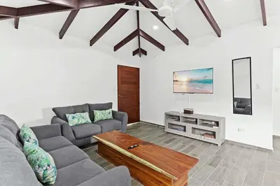 a living room with a couch and a table at Charming Apartment Steps to the Beach in Tamarindo