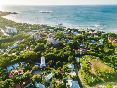 an aerial view of a resort near the beach at Charming Apartment Steps to the Beach in Tamarindo