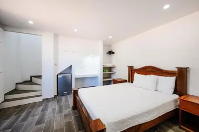 a bedroom with a bed and a tv in it at Charming Apartment Steps to the Beach in Tamarindo