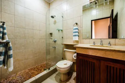 a bathroom with a toilet and a sink and a shower at Ocean-Views, Infinity Pools & Private Veranda in Playa Flamingo