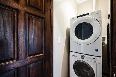 a washer and dryer next to a wooden door at Ocean-Views, Infinity Pools & Private Veranda in Playa Flamingo