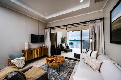 a living room with a couch and a table at Ocean-Views, Infinity Pools & Private Veranda in Playa Flamingo