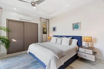 a bedroom with a king sized bed and a closet at Infinity Edge Pool Oceanview 4 BR 4BA in Brasilito