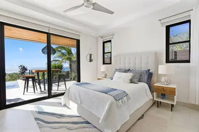 a bedroom with a bed and a view of the ocean at Infinity Edge Pool Oceanview 4 BR 4BA in Brasilito