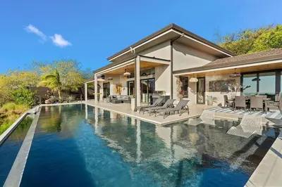 a house with a swimming pool in front of a house at Infinity Edge Pool Oceanview 4 BR 4BA in Brasilito