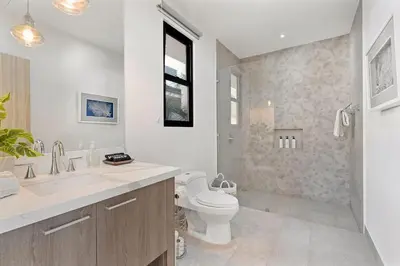 a bathroom with a toilet and a sink and a shower at Infinity Edge Pool Oceanview 4 BR 4BA in Brasilito