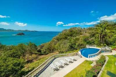an aerial view of a swimming pool and the ocean at Spectacular Ocean View Condo in Playa Flamingo