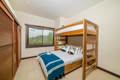 a bedroom with a bunk bed and a window at Spectacular Ocean View Condo in Playa Flamingo