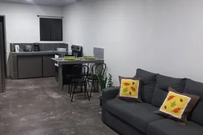 a living room with a couch and a kitchen at Apartamento Sareth in Daniel Flores