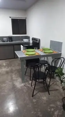 a kitchen with a table with chairs and plates on it at Apartamento Sareth in Daniel Flores