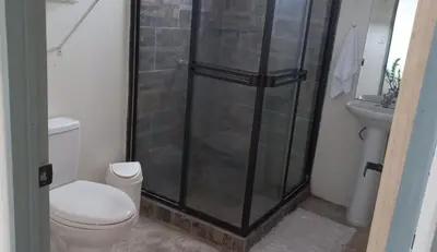 a bathroom with a shower and a toilet and a sink at Apartamento Sareth in Daniel Flores