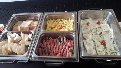 three trays of food with different foods in them at Hotel Wagelia Turrialba in Turrialba