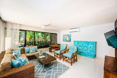 a living room with a couch and chairs at Lush Jungle Paradise - Walk to Beach in Potrero