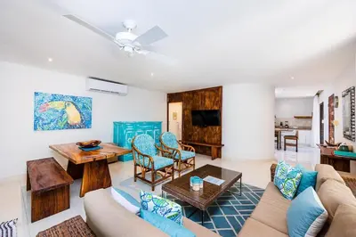 a living room with a couch and a table at Lush Jungle Paradise - Walk to Beach in Potrero