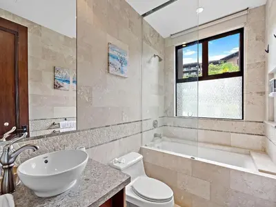 a bathroom with a sink and a toilet and a tub at Spacious Ocean View 3 bd Condo w - Pool in Ocotal