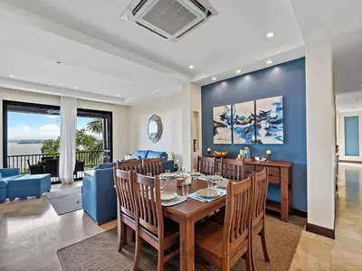 a dining room and living room with a table and chairs at Spacious Ocean View 3 bd Condo w - Pool in Ocotal