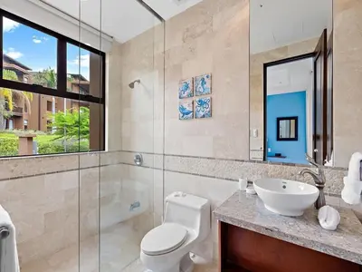 a bathroom with a toilet and a sink and a shower at Spacious Ocean View 3 bd Condo w - Pool in Ocotal