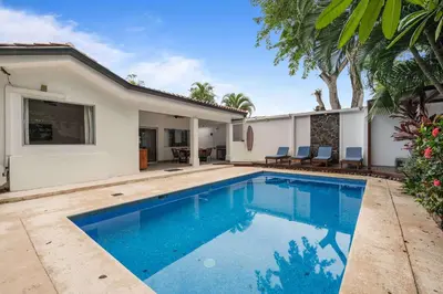 a swimming pool in the backyard of a house at 7 min walk to Surfing Paradise, Pool & Ocean Fun in Playa Grande