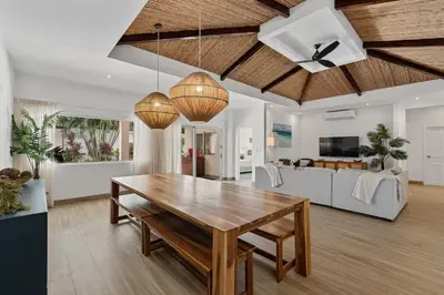 a living room with a wooden table and a couch at 7 min walk to Surfing Paradise, Pool & Ocean Fun in Playa Grande
