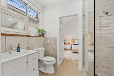 a bathroom with a toilet and a sink and a shower at 7 min walk to Surfing Paradise, Pool & Ocean Fun in Playa Grande