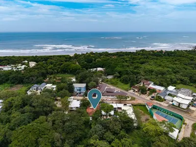 an aerial view of a house with a blue marker at 7 min walk to Surfing Paradise, Pool & Ocean Fun in Playa Grande