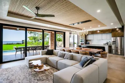 a living room with a couch and a table at Beachfront Luxury Villa, 2 Pools & Daily Breakfast in Playa Flamingo