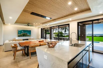 a kitchen and dining room with a table and a couch at Beachfront Luxury Villa, 2 Pools & Daily Breakfast in Playa Flamingo