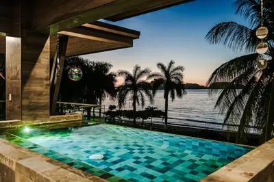 a swimming pool with a view of the water at Beachfront Luxury Villa, 2 Pools & Daily Breakfast in Playa Flamingo