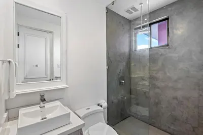 a bathroom with a shower and a toilet and a sink at Garden View, Patio, Steps to Sand with Pool in Potrero