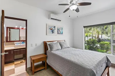 a bedroom with a bed and a mirror and a sink at Garden View, Patio, Steps to Sand with Pool in Potrero